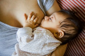 Mother breastfeeding baby girl (0-1 month)